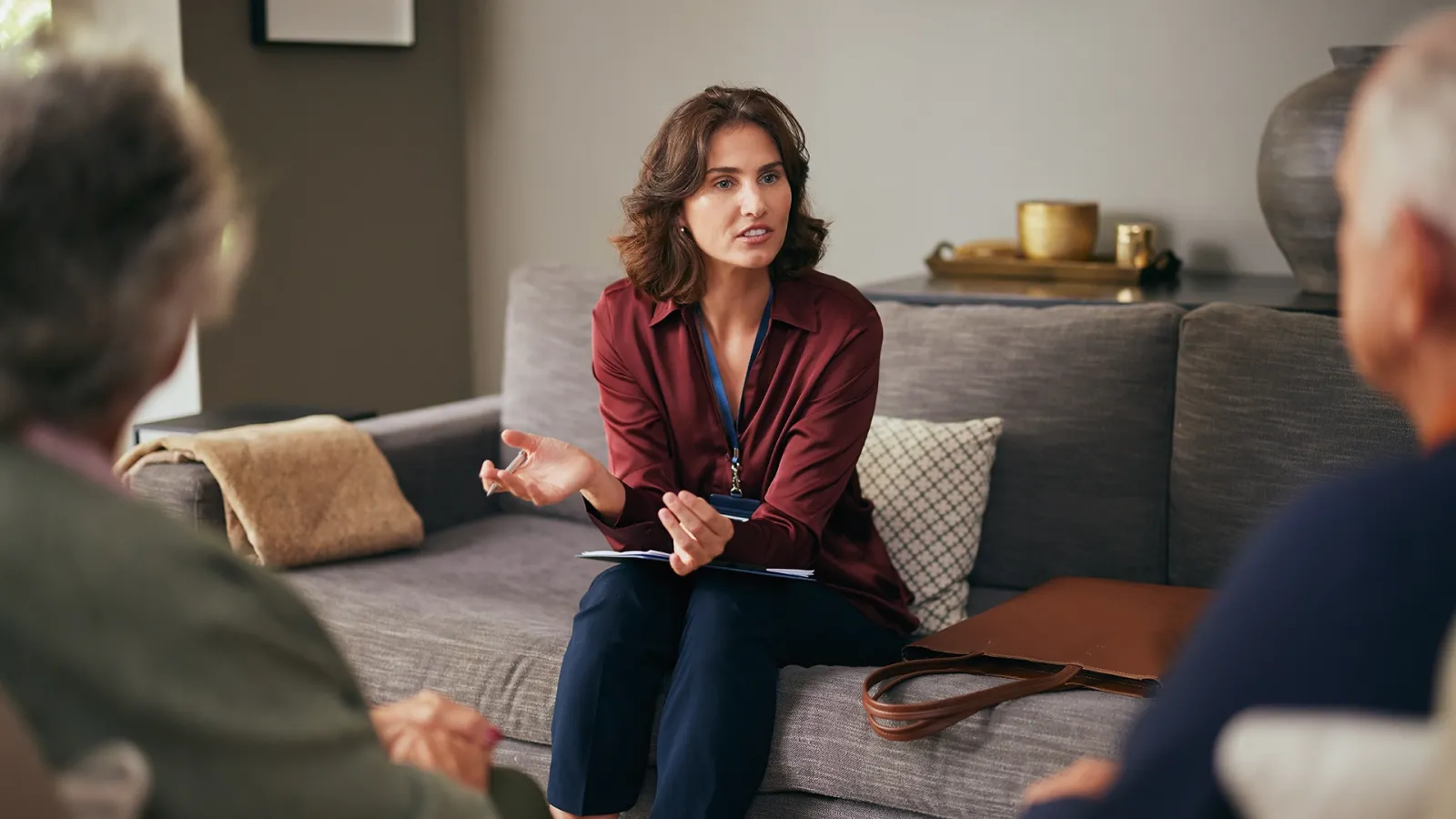 woman talking with couple in their home